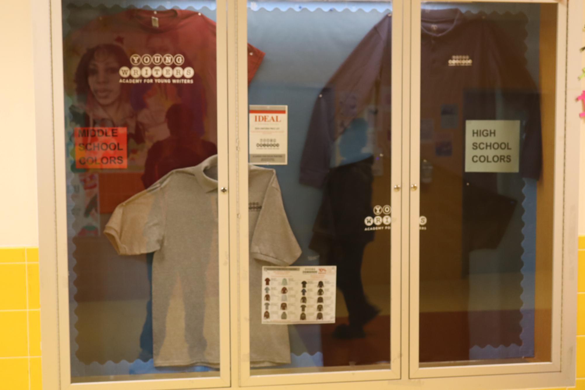 Current AFYW school uniform options displayed in glass showcase on the fourth floor