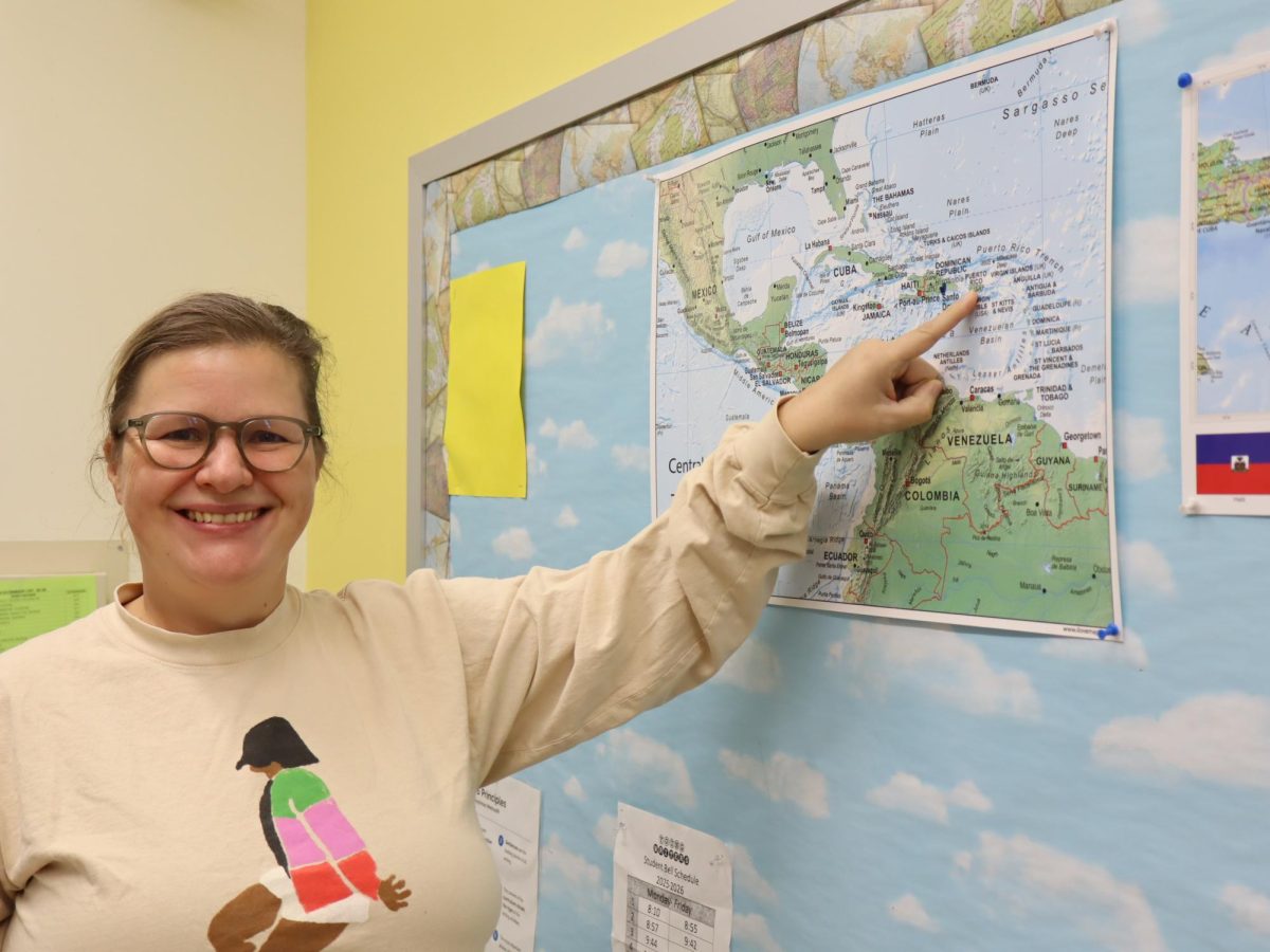 Ms. Justianna pointing to the island of Puerto Rico 